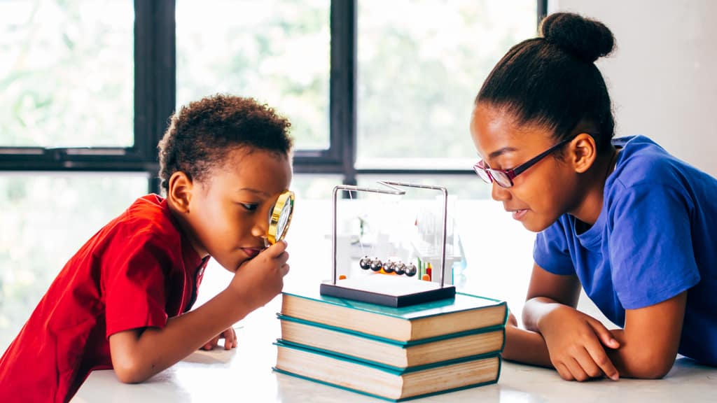 Two children examining a science kit together